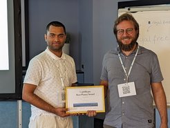 This photo shows Mihir Date receiving the best poster prize at the NGSCES 2023 conference from Prof. Giacomo Mazza.